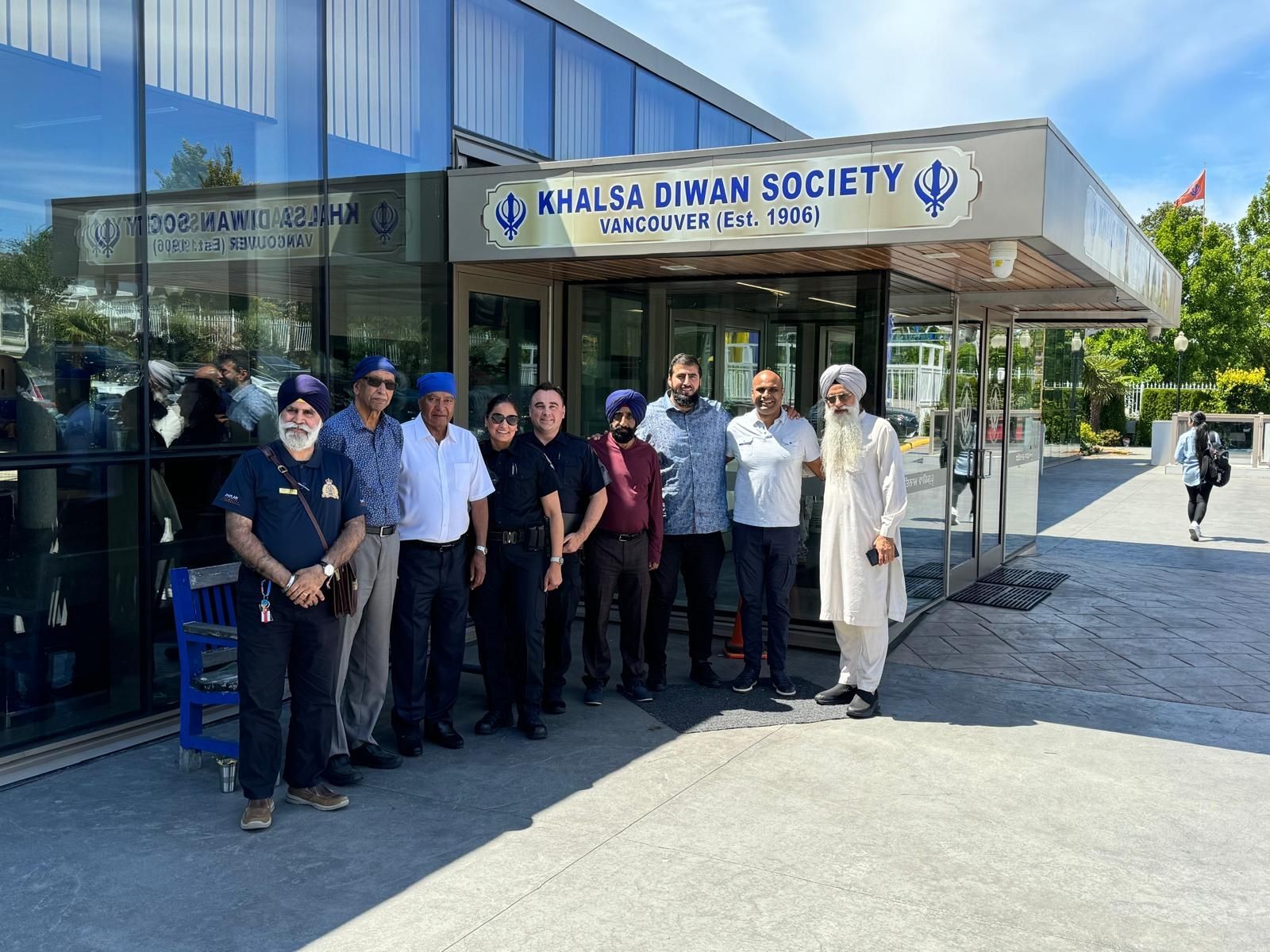 Group of people standing outside the Khalsa Diwan Society building in Vancouver.